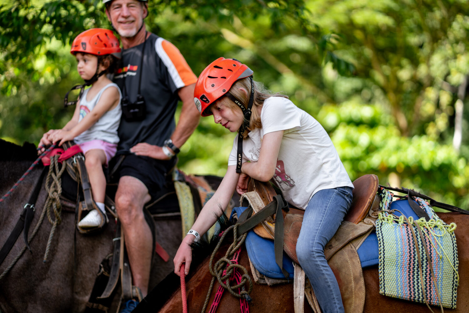 Guest horseback riding through the rainforest at Vista Los Sueños